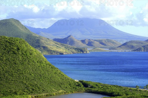 WEST INDIES, St Kitts, View over green hilly coastline and blue sea