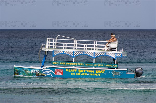 WEST INDIES, Barbados, St James, Tourists on glass bottom boat off the beach at Holetown