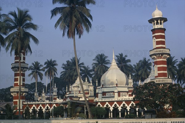 MALAYSIA, Kuala Lumpur, Masjid Jamek or Friday Mosque.  Exterior with domed roof and red and white striped minarets.