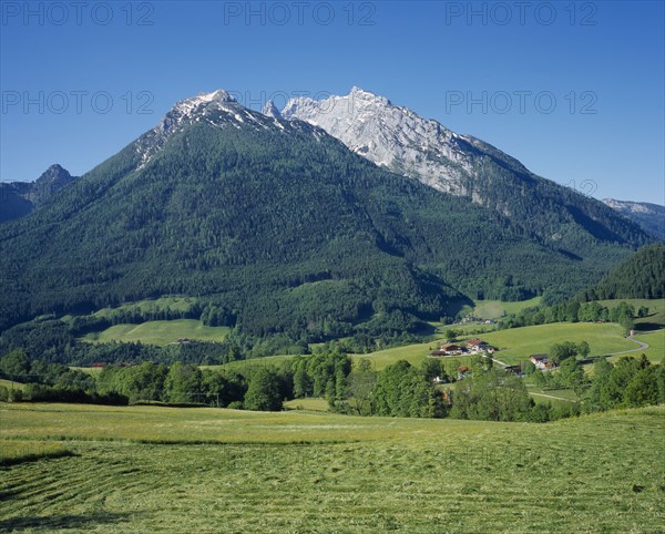 GERMANY, Berchtesgaden, Hockkalter from above Ramsau. Mountain surrounded by grassy fields.