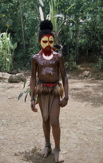 PACIFIC ISLANDS, Melanesia, Papua New Guinea, Southern Highlands. Tari. Huli Tribe. Child dressed for Sing Sing Festival wearing face paint