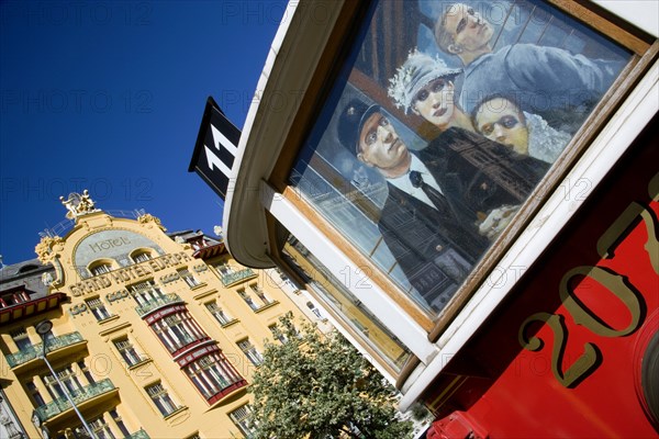 CZECH REPUBLIC, Bohemia, Prague, The 1906 Art Nouveau Hotel Europa in Wenceslas Square with a painting on an old tram outside a cafe in the foreground in the New Town