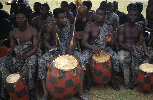 GHANA, Kumasi, Drummers playing at funeral of wife of a chief.