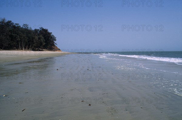 GUINEA BISSAU, Cacheu Region, Varela, "GUINEA BISSAU, Cacheu Region, Varela Atlantic Ocean. View along empty stretch of beach towards the sea. Trees growing next to the sandy beach"