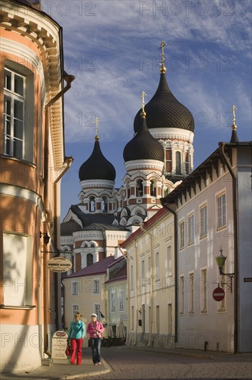 ESTONIA, Tallinn, Two women walking through the Toompea district of the Old Town with Alexander Nevsky Cathedral in the background.