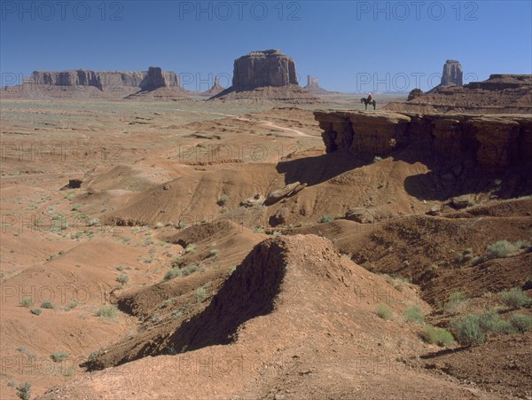 USA, Arizona, Monument Valley, A figure on horseback in the distance on John Ford Point