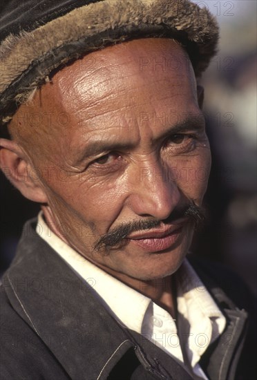 CHINA, Xinjiang Province, Kashgar,  Head and shoulders portrait of Tajik man