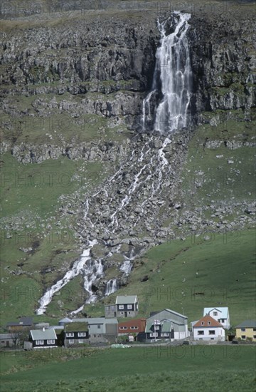 DENMARK, Faeroe Islands, Torshaven, Waterfall and village.