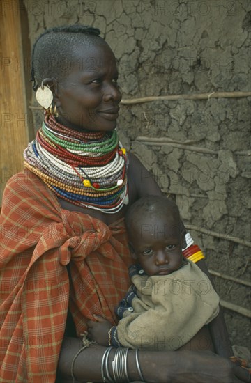 KENYA, Great Rift Valley, Kakuma, Anna Naguie with her baby in Kalobeyei camp for destitute Turkana.