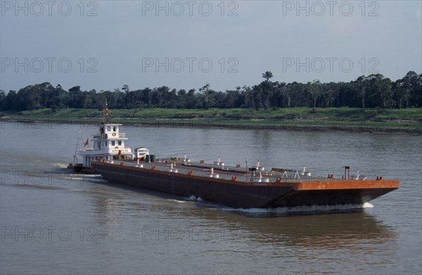 BRAZIL, Amazon, Barge on the Amazon River being pushed upstream towards Manaus.