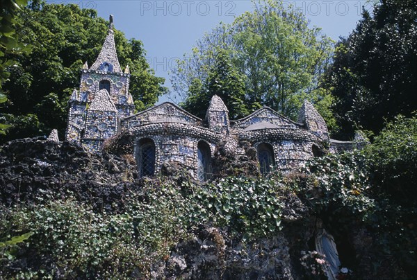 UNITED KINGDOM, Channel Islands, Guernsey, St Andrews. Les Vauxbelets.The Little Chapel surrounded by trees.