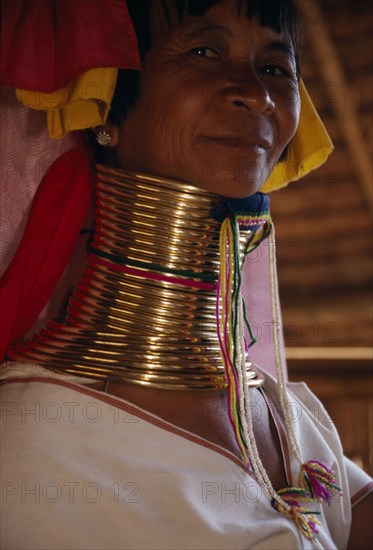 THAILAND, Chiang Rai Province, Mae Chan, Head and shoulders portrait of Paduang ‘long neck’ woman with neck elongated by lengths of coiled brass.