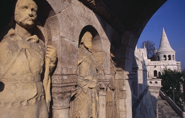 HUNGARY, Budapest, Carved stone figures lining archway with Fishermen s Bastion. Eastern Europe