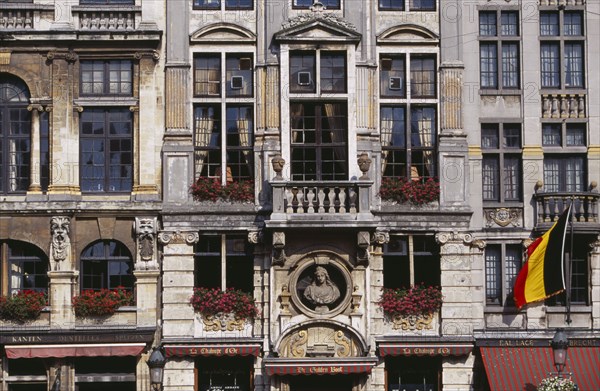 BELGIUM, Brabant, Brussels, Grand Place.  Part view of building facade with stone balconies  flower filled window boxes and tall multi-paned windows. UNESCO World Heritage Site