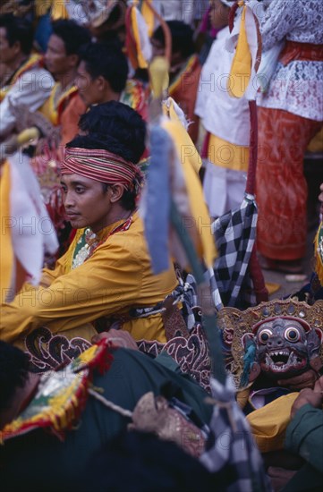 INDONESIA, Bali, Religion, Young man amongst crowd during festival celebrations.