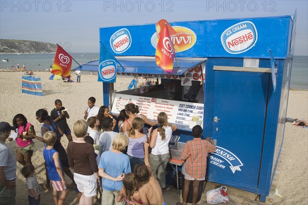 ENGLAND, Dorset, Swanage Bay, A group of children queuing at Ice Cream stall