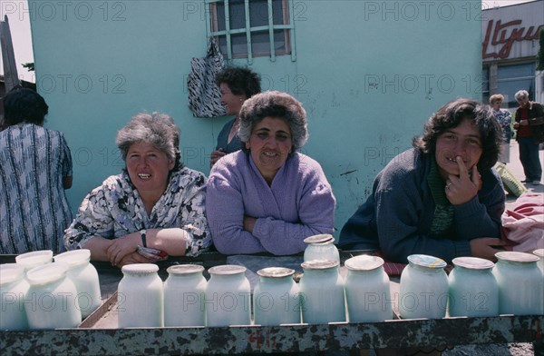 ARMENIA, Yerevan, Women selling yogurt in market.