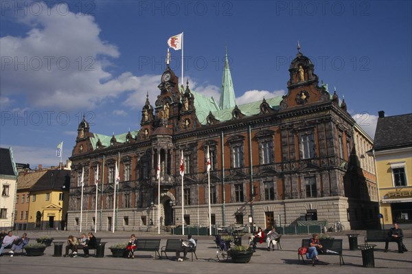 SWEDEN, Malmo, Stortorget City Hall exterior with people sat on benches outside