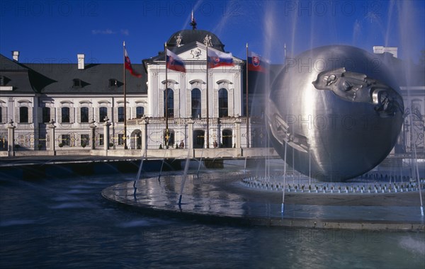 SLOVAKIA, Bratislava, "Presidential Palace, part view of exterior facade with circular, modern ‘Peace’ fountain in the foreground."