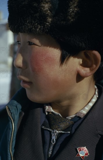 MONGOLIA, Children, Altai provincial capital  Portrait of young boy with Mongolian Communist Party badge in profile to left. East Asia Asian Kids Mongol Uls Mongolian