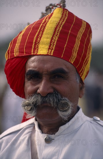 INDIA, Rajasthan, Bikaner, Head and shoulders portrait of a Rajput man with a moustache wearing a turban at the Camel Festival