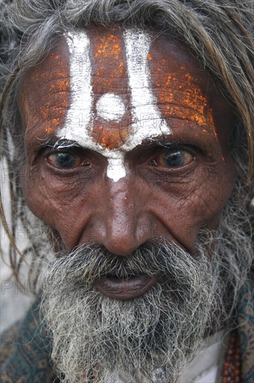 INDIA, Rajasthan, Udaipur, "Portrait of elderly, male Hindu beggar with grey beard and painted forehead outside the Jagdish Temple. "