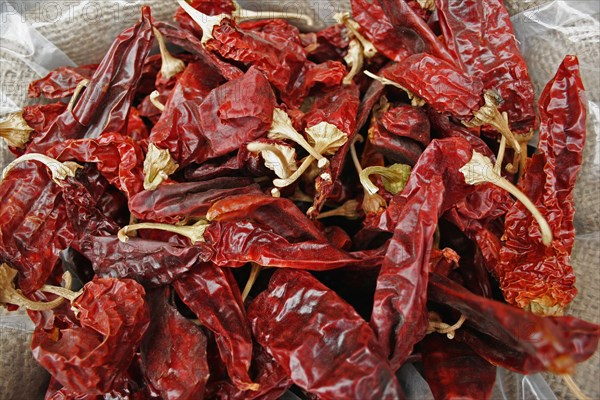 ISRAEL, Jerusalem, "Jerusalem food market.  Open sack of dried, red, hot chili peppers, close cropped view filling frame."