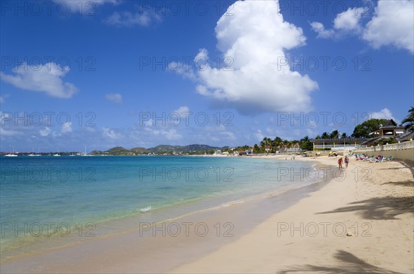 WEST INDIES, St Lucia, Gros Islet, Reduit Beach in Rodney Bay with tourists in the water and on the beach