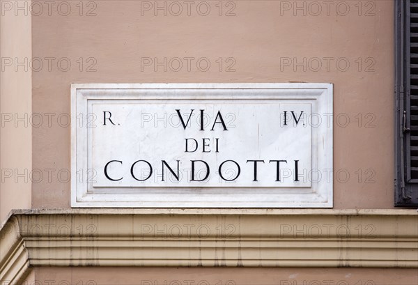 ITALY, Lazio, Rome, Marble street sign on a wall for Via Dei Condotti the high fashion shopping street