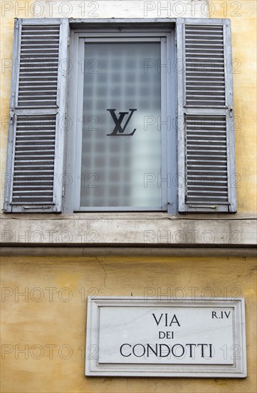 ITALY, Lazio, Rome, Road sign for the Via dei Condotti on the wall of the Louis Vuiton shop in the main shopping street in Rome