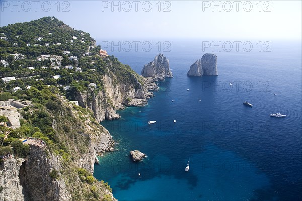 20093664 ITALY Campania Island of Capri Faraglioni Rocks from Punta del Cannone viewpoint with Augustus Gardens bottom left