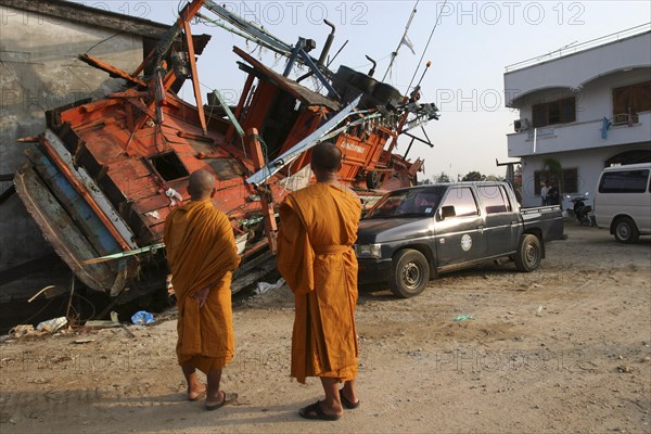 THAILAND, Phang Nga District, Nam Khem, "Tsunami. Monks looks at the damage caused by the tsunami, nothing is left standing in the village 2500 people are pressumed dead. 125kms north of Phuket on the 2nd Jan."