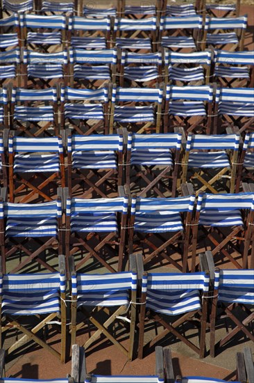 ENGLAND, East Sussex, Eastbourne, Details of blue and white deck chairs at the band stand.