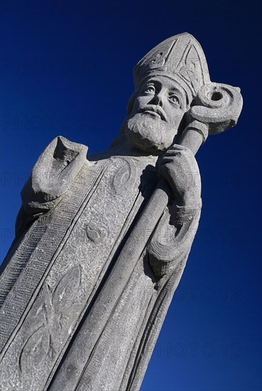 IRELAND, County Mayo, Downpatrick Head, Statue of St Patrick, who prayed frequently in the church.