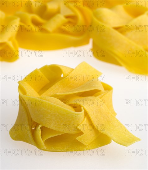 Food, Uncooked, Pasta, Ribbons of durum wheat Pappardelle against a white background.