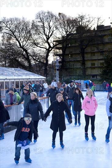 England, East Sussex, Brighton, Royal Pavilion Ice Rink  people skating.