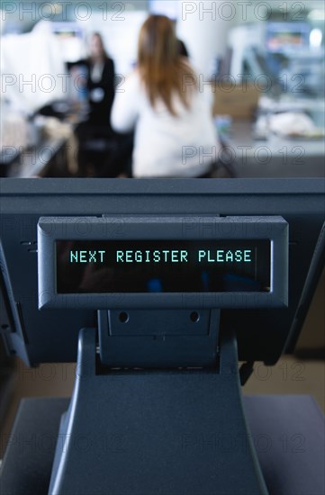 Ireland, County Dublin, Dublin City, Ballsbridge  Lansdowne Road  Aviva Stadium Unattended cash register with a digital readout that says Next Register Please with people in the background.