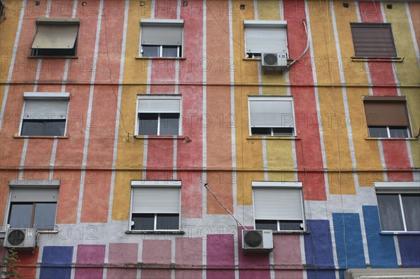 Albania, Tirane, Tirana, Part view of exterior facade of striped  multi-coloured apartment building.