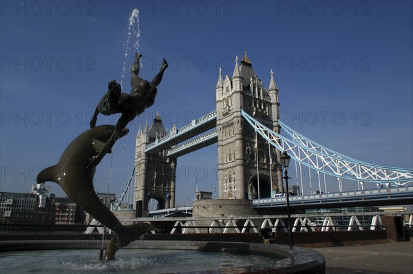 England, London, Tower Bridge with sculpted fountain in the foreground