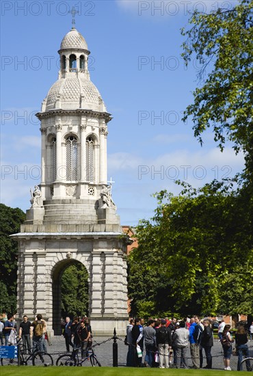 Ireland, County Dublin, Dublin City, Trinity College university with people walking through Parliament Square towards the Campanile.