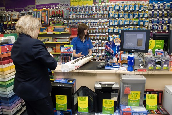 Rymans office staionery store with female shop assistant serving female customer. Photo : Paul Seheult