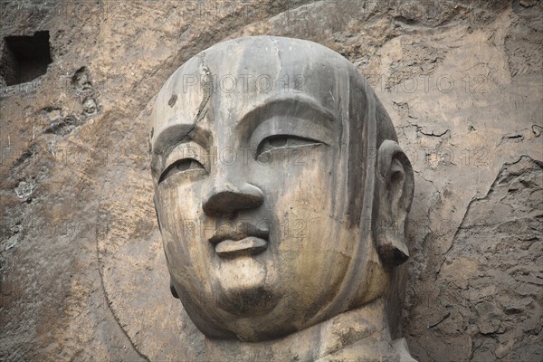 Carved Buddha statue in the Fengxian Temple Tang Dynasty Longmen Grottoes and Cave. Photo : Mel Longhurst