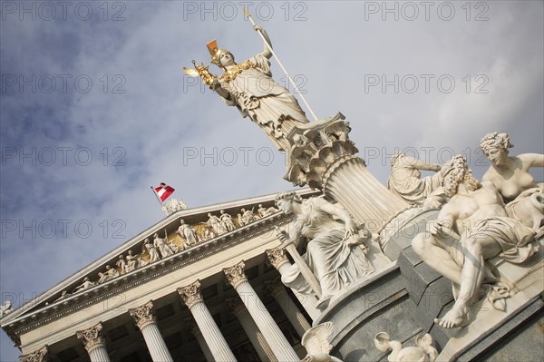 Angled view of statue of Athena raised on pillar above fountain in front of the Parliament building. Photo : Bennett Dean