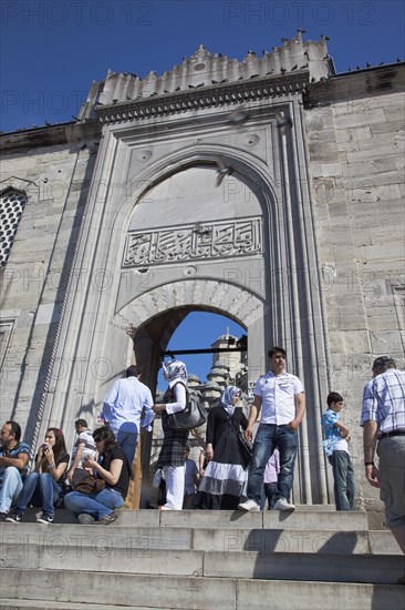 Turkey, Istanbul, Eminonu Yeni Camii New Mosque people on steps by the entrance. 
Photo : Stephen Rafferty