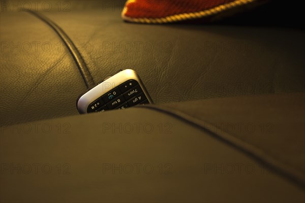 Communications, Telephones, Mobile, Phone stuck between cushions of leather sofa. 
Photo : Stephen Rafferty