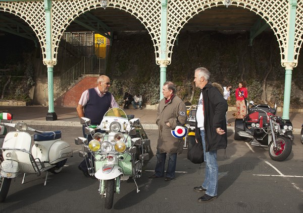 Elaborately decorated Mopeds on Madeira Drive during motorbike festival.