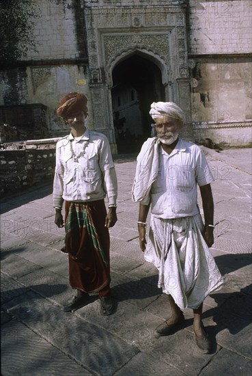 Rajasthani men stand near one of the seven gates of Meherangarh Fort.
Jodhpur, Western Rajasthan, India.